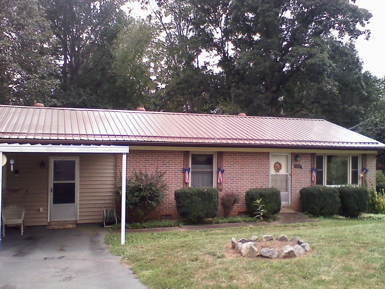Bronze metal roof and carport on a brick ranch home — Roof Repair work by our crew in Skokie
